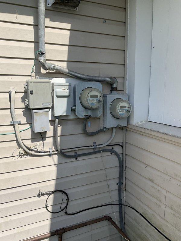 Performed on-site evaluation of existing HVAC system with R-22 refrigerant. Determined existing air conditioning unit was low on refrigerant and not economically viable for repair due to age and refrigerant phase-out. Documented current furnace installation and exterior electrical service configuration. Provided estimate for complete air conditioning system replacement with modern, environmentally-compliant equipment. Photographed existing equipment and utility connections for replacement planning purposes.