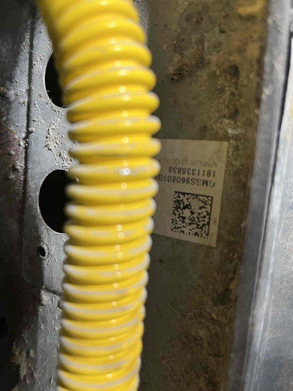 Responded to no cooling call on AC unit that had stopped running. Upon inspection, found control board and compressor wiring connections intact with proper color coding to CAP2XH4037L4 compressor assembly. Verified electrical connections at circuit board and traced conduit routing through wall penetration. System components showed professional installation with organized wire management and proper labeling. Documented internal cabinet configuration and external conduit pathway for service records.