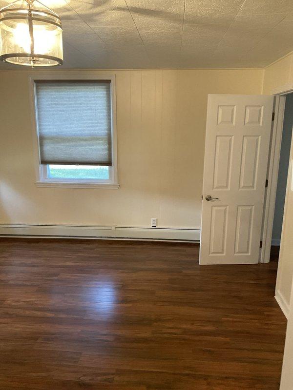 Conducted on-site assessment for air conditioning system replacement in residential property with boiler heating system. Evaluated interior space with baseboard heating to determine optimal equipment placement and sizing requirements. Documented existing conditions and room layout to prepare comprehensive replacement estimate for new AC unit installation.