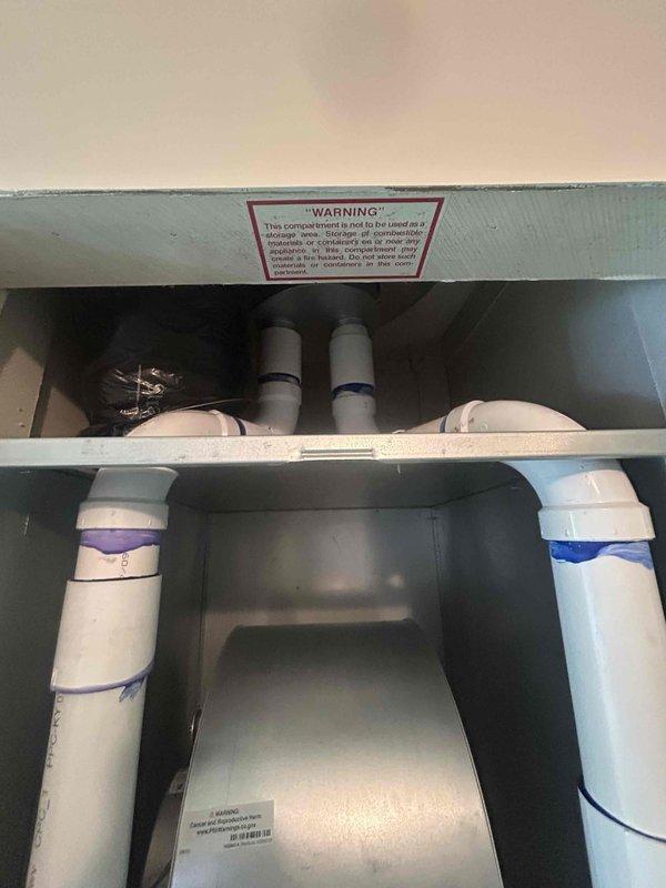 Responded to callback for HVAC installation issue where venting and ceiling area above the furnace coil had a large 8-12 inch opening that required sealing. Inspected the mechanical compartment and ductwork installation in the attic space, documenting the condition of the flex duct connection, metallic transition pieces, and PVC drain lines running through the system. Sealed the gap in the ceiling/venting area above the evaporator coil to prevent air leakage and ensure proper system operation and efficiency.