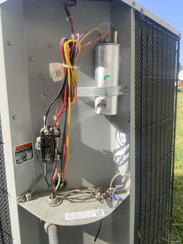 Responded to no cooling complaint on 10+ year old outdoor HVAC unit. Upon arrival, performed diagnostic inspection of outdoor condensing unit and accessed internal electrical compartment. Inspected capacitor, contactor, and all electrical connections for proper operation. Noted unit showed signs of age with accumulated debris in base of compartment. Replaced existing thermostat inside home with new user-friendly thermostat provided by family member to improve ease of operation for homeowner. Verified all wire connections secure and properly terminated. Documented equipment condition with photos showing capacitor, contactor assembly, and wiring configuration. Discussed system age and potential need for replacement unit consideration with homeowner given equipment is beyond typical service life expectancy.