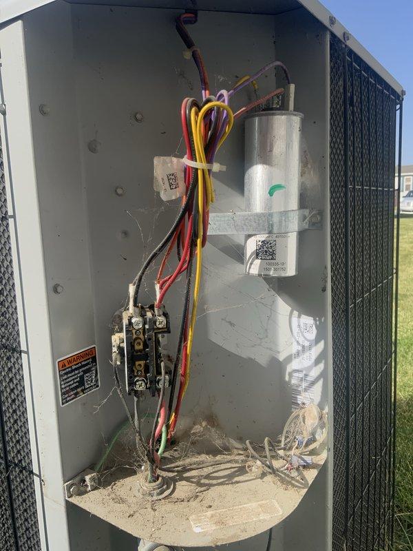 Responded to no cooling complaint on 10+ year old outdoor HVAC unit. Upon arrival, performed diagnostic inspection of outdoor condensing unit and accessed internal electrical compartment. Inspected capacitor, contactor, and all electrical connections for proper operation. Noted unit showed signs of age with accumulated debris in base of compartment. Replaced existing thermostat inside home with new user-friendly thermostat provided by family member to improve ease of operation for homeowner. Verified all wire connections secure and properly terminated. Documented equipment condition with photos showing capacitor, contactor assembly, and wiring configuration. Discussed system age and potential need for replacement unit consideration with homeowner given equipment is beyond typical service life expectancy.