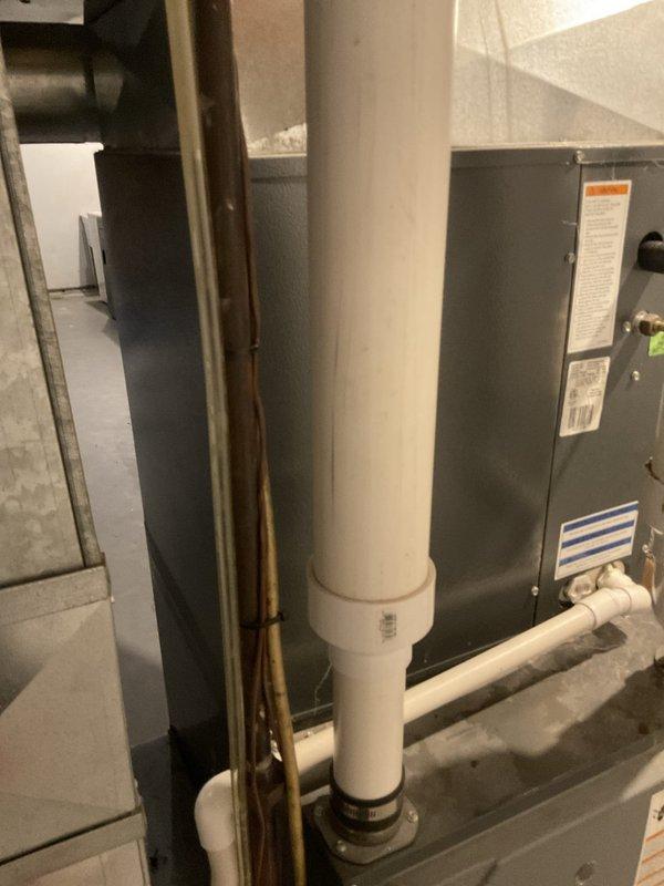 Conducted comprehensive assessment of non-operational air conditioning system and aging HVAC equipment located in basement utility area. Evaluated existing furnace, air handler, and associated ductwork and drainage systems to provide equipment replacement estimate. Documented current installation configuration including PVC venting, copper refrigerant lines, and electrical connections to determine proper sizing and specifications for new system components.