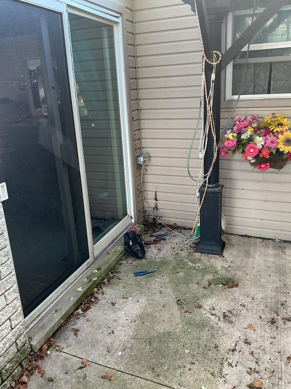 Installed a new GFCI outlet on the outdoor patio area to provide ground fault protection for the exterior living space. The installation ensures safe electrical operation in this weather-exposed environment near the air conditioning unit and outdoor furnishings.