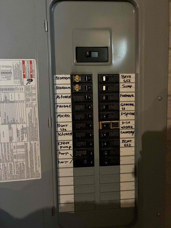 Conducted comprehensive assessment of existing HVAC system for replacement estimate. Evaluated gray metal air handler unit and associated ductwork in basement mechanical room. Inspected electrical panel to verify circuit capacity and breaker configuration for furnace and air conditioning power requirements. Documented current equipment specifications, installation conditions, and electrical infrastructure. Photographed existing air handler, PVC condensate drainage, electrical panel with labeled circuits including dedicated furnace and A/C breakers, and basement mechanical room layout to prepare itemized quotes for individual furnace replacement, air conditioning system replacement, and bundled furnace and AC replacement package.