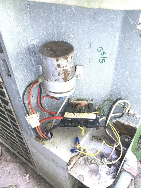# HVAC Service Report

Responded to no cooling complaint on outdoor condensing unit. Upon arrival, found extensive debris accumulation around and on top of equipment, including dead leaves, dried vegetation, and organic matter restricting airflow. Observed visible rust and corrosion on capacitor housing and metal components indicating prolonged environmental exposure. Cleared all debris from unit exterior, base, and surrounding area. Inspected electrical connections and found wiring intact with proper terminations at contactor and capacitor. Cleaned interior cabinet surfaces of accumulated dirt and dust. Verified proper electrical operation of contactor and capacitor function. Unit restored to normal cooling operation after debris removal and cleaning.