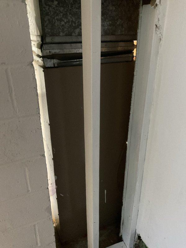 Conducted replacement consultation for 30+ year old residential air conditioning system that had ceased operation. Evaluated existing outdoor condensing unit and interior ductwork distribution system, documenting current equipment condition and installation configuration. Assessed vertical chase containing supply ductwork and register locations, noting flexible duct connections and wall-mounted supply vents. Photographed existing HVAC infrastructure including air distribution pathways and interior ductwork access points to support replacement system design and equipment sizing recommendations. Provided homeowner with comprehensive options for complete system replacement to restore whole-home cooling capacity.