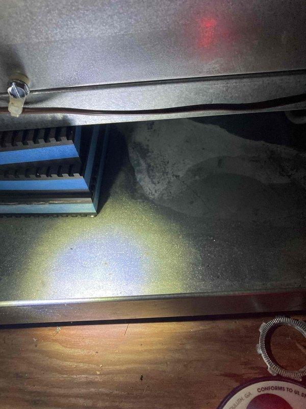 Responded to no cooling call for club AC unit. Upon arrival, performed diagnostic inspection of system components including evaporator coil and electrical connections. Measured voltage at capacitor terminals using digital multimeter, recording 11.99 volts. Inspected refrigerant lines, mounting hardware, and heat exchanger assembly. Documented equipment condition with photos for maintenance records.