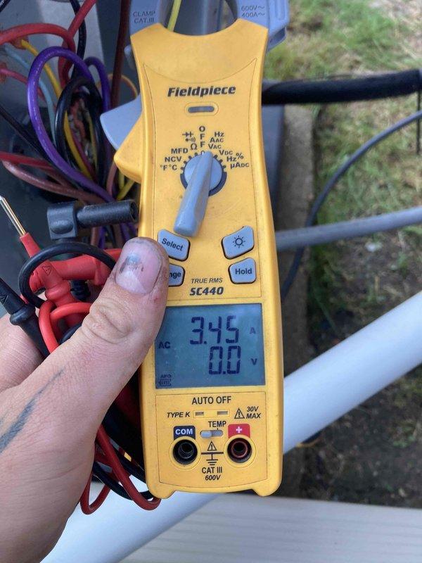 Responded to service call for non-operational AC system on units 4-6 under maintenance agreement. Performed diagnostic assessment using calibrated digital temperature measurement equipment to verify thermostat accuracy and system performance. Thermostat displayed 75°F, confirmed with handheld Klein Tools temperature meter reading 75.7°F, indicating proper sensor calibration. Conducted electrical diagnostics on outdoor condensing unit using Fieldpiece SC440 clamp meter, measuring voltage and amperage at compressor connections. Recorded 345V reading during testing to assess power supply and component operation. Inspected wiring connections and electrical components for proper function. System evaluated and measurements documented for maintenance records.