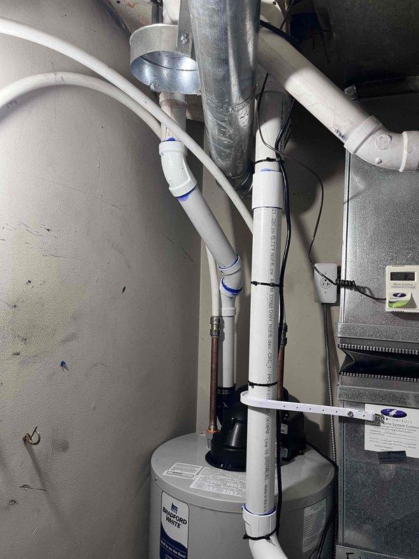 Completed installation of a 40-gallon power vent water heater in residential utility room. Removed existing unit and installed new water heater with proper mounting, connected water supply lines with shut-off valves, established all necessary plumbing connections, and installed power vent system with appropriate PVC venting. Verified all electrical connections to control box, tested unit operation, confirmed proper venting function, and ensured all safety controls and temperature settings were properly configured per manufacturer specifications.