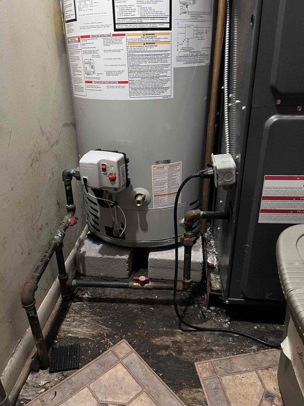 Completed installation of a 40-gallon power vent water heater in residential utility room. Removed existing unit and installed new water heater with proper mounting, connected water supply lines with shut-off valves, established all necessary plumbing connections, and installed power vent system with appropriate PVC venting. Verified all electrical connections to control box, tested unit operation, confirmed proper venting function, and ensured all safety controls and temperature settings were properly configured per manufacturer specifications.