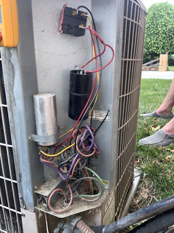 Responded to no-cool call on 30-year-old AC unit that had frozen up and produced unusual noise before being shut down. Upon arrival, inspected outdoor condenser unit and found electrical components requiring attention, including capacitor and contactor connections. Examined blower assembly and noted corrosion on motor shaft, indicating age-related deterioration consistent with unit's service life. Documented internal electrical panel condition with tangled wiring and multiple connections to capacitor. Given the advanced age of the system and extent of wear observed, provided customer with assessment of current condition and recommended replacement options, as repair costs would not be cost-effective for equipment at end of expected lifespan.