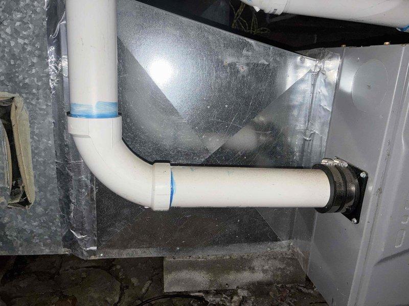 Conducted comprehensive assessment of non-operational air conditioning system with aging 2-ton to 4-ton capacity unit. Inspected air handler unit located in crawl space, evaluating overall condition of equipment including cabinet integrity, access panel security, and surrounding installation environment. Documented existing PVC condensate drainage system with proper trap configuration and mounting hardware. Photographed current equipment setup showing air handler mounted on concrete pad with metallic supply ductwork connections and white PVC drain line secured with appropriate clamps. Assessed crawl space conditions including clearances, floor surface, and accessibility for replacement work. Provided customer with detailed estimate for complete system replacement due to age and operational failure of existing equipment.