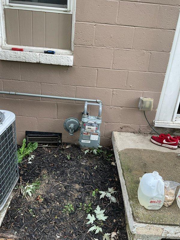Conducted comprehensive site assessment for air conditioning replacement at residential property. Evaluated existing HVAC system configuration featuring ComfortMaker furnace installed in interior utility closet with associated ductwork and components. Documented current equipment specifications, installation layout, and utility connections including gas meter location on exterior wall. Photographed indoor furnace unit, duct configuration, and outdoor AC unit positioning to prepare detailed equipment replacement estimate. Assessed access points, electrical service availability, and clearance requirements for new air conditioning system installation.