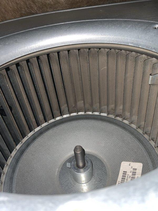 Responded to no cooling complaint on residential HVAC system. Upon inspection, found unit blowing warm air through vents. Accessed electrical control panel and blower assembly to diagnose issue. Inspected capacitor, wiring connections, and blower wheel condition. Blower wheel showed dust accumulation on fins which can restrict airflow and reduce system efficiency. Electrical connections at terminal block appeared intact with proper wire management. System components showed normal wear consistent with age of equipment. Addressed cooling failure and restored proper operation.