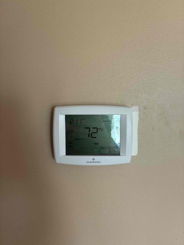 Conducted on-site evaluation of existing HVAC system for replacement estimate. Assessed current air handler unit located in attic space and existing Emerson programmable thermostat set to 72°F. Documented equipment conditions, ductwork connections, electrical service panel configuration, and installation environment. Captured photographic documentation of existing components to support replacement recommendations and equipment sizing requirements.