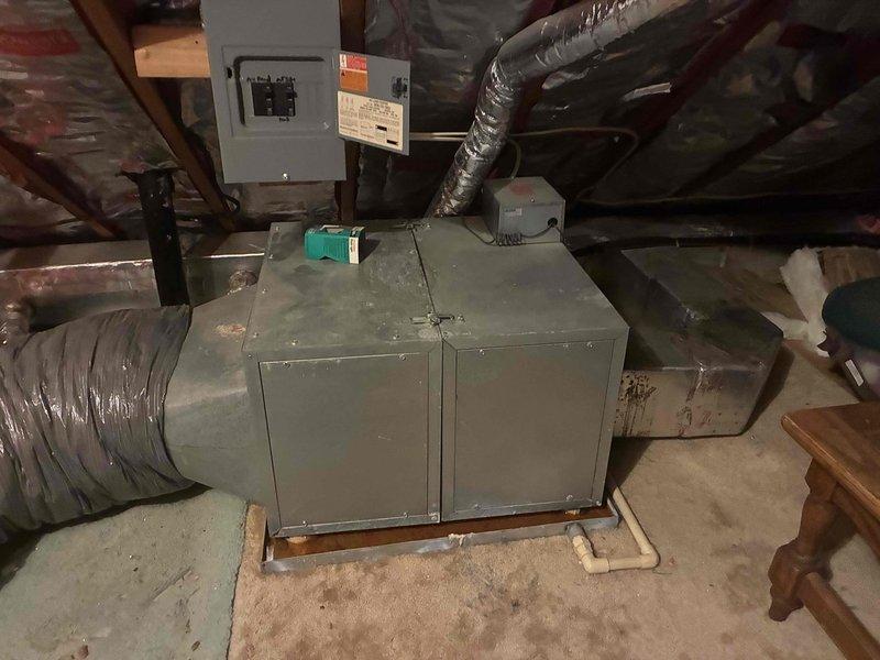Conducted on-site evaluation of existing HVAC system for replacement estimate. Assessed current air handler unit located in attic space and existing Emerson programmable thermostat set to 72°F. Documented equipment conditions, ductwork connections, electrical service panel configuration, and installation environment. Captured photographic documentation of existing components to support replacement recommendations and equipment sizing requirements.