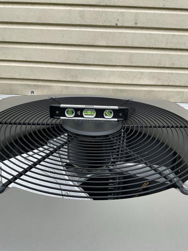 Responded to service call for 5-year-old AC unit with reduced cooling capacity. Performed diagnostic evaluation of outdoor condensing unit, checked refrigerant levels and pressures, and verified unit levelness using precision leveling tool. System found to be operating but not achieving optimal cooling performance, requiring further assessment of airflow and refrigerant charge to restore full cooling capacity.