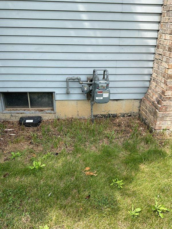 Conducted on-site evaluation for complete HVAC system replacement including 10-year-old furnace located in basement and 20-year-old air conditioning unit positioned on exterior concrete pad. Both units currently operational but nearing end of service life. Documented existing equipment configuration, photographed outdoor condenser unit with connected refrigerant lines and electrical conduit, assessed gas meter location and utility connections for furnace replacement planning. Provided comprehensive replacement estimate featuring mid-range equipment options suitable for home preparation prior to sale.