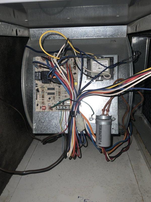 Responded to no cooling call on 21-year-old air conditioning system with indoor temperature at 85°F. Upon arrival, confirmed furnace and blower motor operational and thermostat functioning properly with fresh batteries installed. Inspected outdoor condensing unit and found significant debris accumulation in base including leaves, dirt, and organic matter. Opened electrical compartment and performed visual inspection of contactor, capacitor, control board, and all electrical connections. Assessed wiring condition on 21-year-old system, noting multiple wire connections to capacitor and control components. Documented internal electrical components and overall system condition with photos. Based on age of equipment and operational assessment, provided recommendations for system replacement due to unit exceeding typical service life expectancy. Discussed repair versus replacement options given the advanced age of both the air conditioning and furnace systems.
