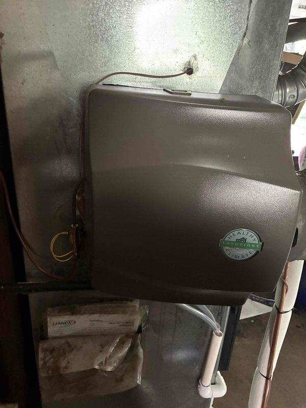 Completed full HVAC system installation including a 90,000 BTU Lennox furnace with humidifier in the basement utility area and a 3-ton air conditioning condenser unit in the rear yard. Performed all mechanical and electrical connections, installed new Lennox programmable thermostat, connected PVC condensate drainage, established copper refrigerant lines, and reconnected all ductwork to ensure proper system operation.