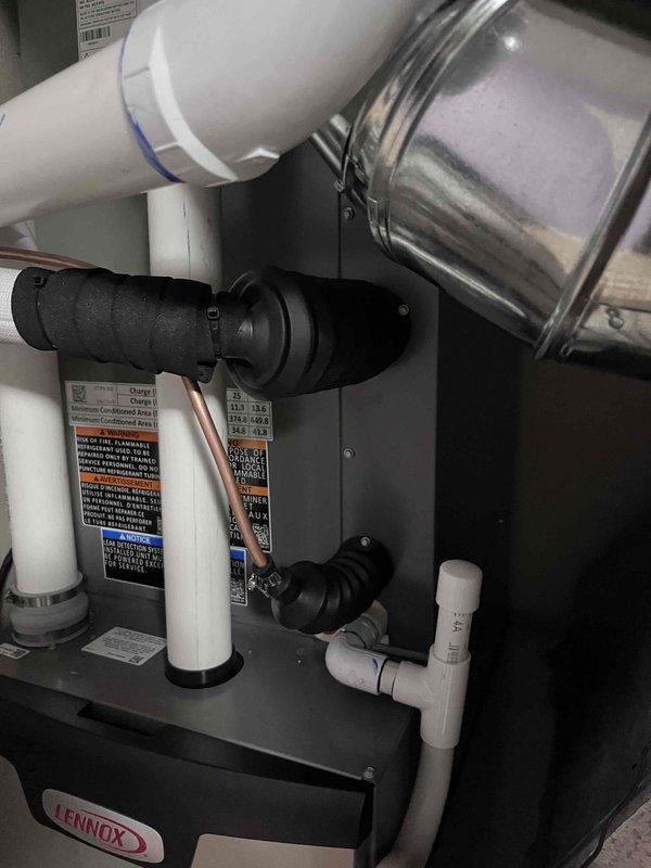 Completed full HVAC system installation including a 70,000 BTU Lennox furnace, 3-ton Lennox air conditioning unit, and humidifier system. The outdoor AC unit was positioned on a concrete pad in the rear yard with proper electrical conduit installation and connection. Interior mechanical components were installed in the utility area with all necessary plumbing connections, PVC venting, and copper supply lines properly configured. All equipment was reconnected, tested for proper operation, and system commissioning was successfully completed.