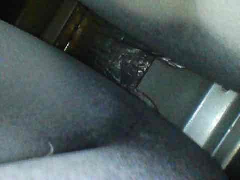 Completed preventive maintenance inspection on air conditioning system under Club AC8-12 agreement. Inspected evaporator coil and found moderate accumulation of dust and debris on fins, with visible oxidation and discoloration indicating extended service period. Examined ductwork connections in confined access area, noting dust buildup on metallic surfaces and joint connections. Documented system condition with photos for maintenance records. Unit operational at time of inspection.