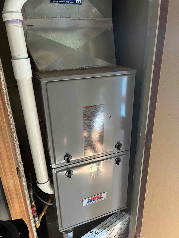 Conducted comprehensive assessment of existing HVAC system for equipment replacement estimate. Air conditioning unit currently non-operational while natural gas furnace remains functional. Documented existing thermostat wiring configuration showing proper terminal connections for R, Rc, W2, Y, G, C, and O/B wires at control panel mounted on interior wall. Photographed current furnace installation in utility closet, noting existing sheet metal plenum with reinforcement, PVC condensate drain lines with proper purple primer application at joints, and overall system layout within confined mechanical space. Evaluated equipment age, operational status, and installation conditions to provide accurate replacement recommendations for complete HVAC system upgrade.