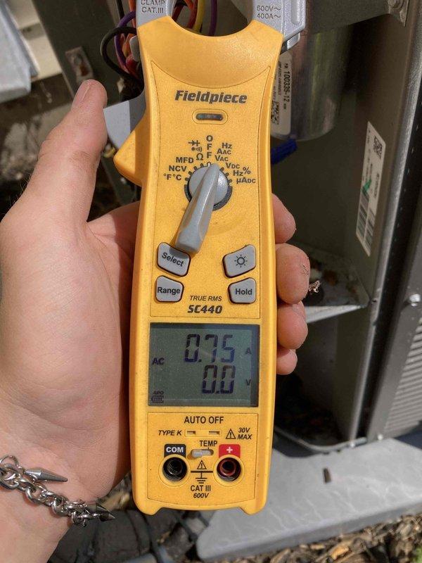 # No Cooling After Power Outage - 5-Year-Old AC System

Responded to a no cooling call on a 5-year-old residential air conditioning system that stopped cooling following a recent power outage. Upon arrival, confirmed the system was running but not producing cool air throughout the home.

Performed a comprehensive system evaluation beginning with the indoor air handler unit. Inspected the blower assembly and confirmed the blower wheel was operational and rotating properly, though noted moderate dust accumulation on the blades that could impact airflow efficiency. Verified blower motor operation and mechanical components were functioning without unusual noise or binding.

Proceeded with electrical diagnostics using a digital multimeter to test system voltages and capacitance values. Measured capacitor performance on the blower motor, recording readings of 0.75 MFD against manufacturer specifications. Tested electrical connections at the air handler, verifying proper voltage supply had be