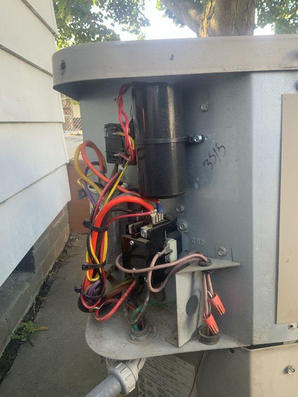 # HVAC Service Report: No Cool - Aged System

Responded to service call for 23-year-old air conditioning system with reported condenser fan motor malfunction and diminished cooling capacity. Upon arrival, performed visual inspection of outdoor condensing unit and verified fan motor was operating intermittently with reduced RPM. Opened electrical disconnect box and inspected internal components, noting significant age-related deterioration including corroded terminals, accumulated debris, and weathered wiring connections.

Tested voltage at disconnect and contactor, confirming power supply to unit. Removed access panel on condensing unit to examine dual capacitor, contactor assembly, and associated wiring harness. Measured capacitance values on run capacitor serving both compressor and fan motor circuits, finding fan motor capacitor section reading below manufacturer specifications. Inspected contactor contacts for pitting and proper closure during operation.

Performed amp draw test on