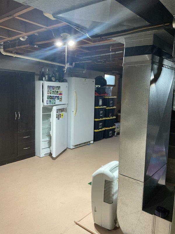 Provided comprehensive estimate for new air conditioning system installation at residential property currently without cooling equipment. Assessed basement location with existing natural gas furnace and ductwork infrastructure, noting exposed ceiling joists and existing HVAC distribution system. Evaluated exterior placement options for condenser unit near foundation on side yard with adequate clearance, documented existing electrical service routing, and determined equipment specifications and installation requirements for complete AC system integration with current heating system.