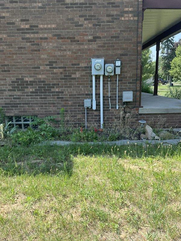 # Electrical Estimate - Generator Installation

Conducted comprehensive site assessment for whole home standby generator installation and air conditioning unit replacement. Evaluated existing electrical service infrastructure, including dual utility meter configuration and current disconnect panel mounted on brick exterior wall. Documented weathered deck area adjacent to existing HVAC equipment location, noting proximity to electrical service connection point with existing conduit and receptacle. Assessed accessibility for generator placement considering clearance requirements from structure, existing AC unit positioning, and electrical service entry points. Evaluated electrical panel capacity and determined requirements for automatic transfer switch installation, load calculations, and necessary permits. Photographed meter base location, service disconnect, and proposed equipment placement areas to develop accurate material list and labor estimate for generator system integration with