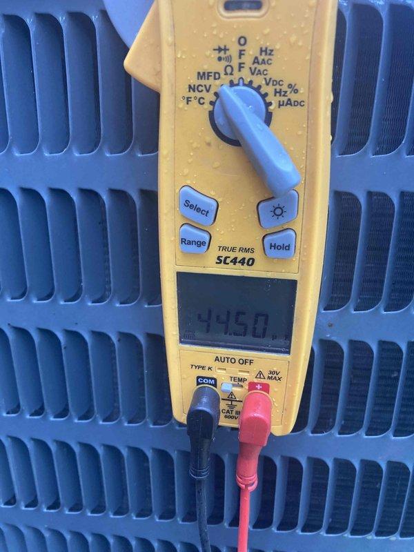 # HVAC Service Report

Responded to no cooling complaint on air conditioning system. Upon arrival, performed diagnostic testing of the outdoor condensing unit. Utilized digital multimeter to measure electrical parameters and temperature readings across the condenser coil. Display readings indicated temperature differential of 44.5 degrees, suggesting potential refrigerant flow or heat exchange issues. Inspected condenser coil fins for proper airflow and system operation. Documented equipment conditions with diagnostic measurements for service records.