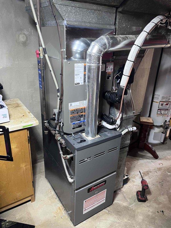 Completed installation of 2.5-ton air conditioning system with evaporator coil in rear configuration. Unit was mechanically and electrically connected to existing furnace system, with all refrigerant lines properly installed and vacuum tested to 2857 microns to ensure system integrity. All ductwork connections were secured, electrical reconnections completed per code requirements, and system commissioned with successful startup verification.