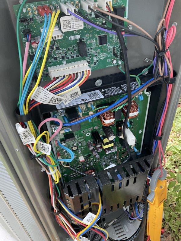 Completed warranty service for control board replacement on outdoor HVAC unit. Replaced defective circuit board 2-6 within the multi-board electronic control system, verified proper wiring connections at terminal block including hot conductors and ground wire, and confirmed all ribbon cable connections and conduit fittings were secure. Unit tested successfully with all electronic components functioning properly upon completion.