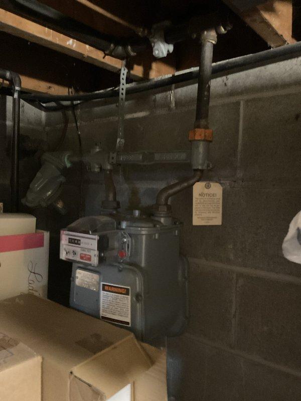 Provided electrical estimate for whole home generator replacement to address failed transfer switch and circuit board on 17-year-old existing unit. Assessed natural gas meter and utility connections in basement area to verify adequate fuel supply capacity for new generator installation. Documented existing HVAC and gas infrastructure to ensure proper clearances and code-compliant integration with replacement generator system.