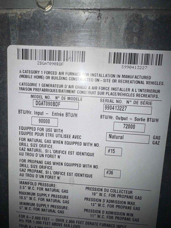 Responded to no-cool call on 9-year-old central air conditioning system. Upon arrival, confirmed unit was not providing cooling to the residence. Documented equipment information from manufacturer data plate on furnace unit (Model: DGAT090BDF, Serial: 990413227, 90,000 BTU/Hr input natural gas forced air furnace). Photographed system components and insulation board near HVAC equipment for service records.