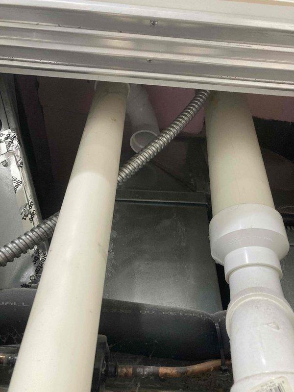 Completed AC CLUB 12-4 preventive maintenance agreement visit. Performed comprehensive inspection of air conditioning system and supplemental items, including examination of drain pan condition, condensate drainage system with PVC piping, flexible ductwork connections, and air handler components. All system components were inspected and photographed for documentation purposes, with drain pan showing normal condensation levels and all piping connections secure and functioning properly.