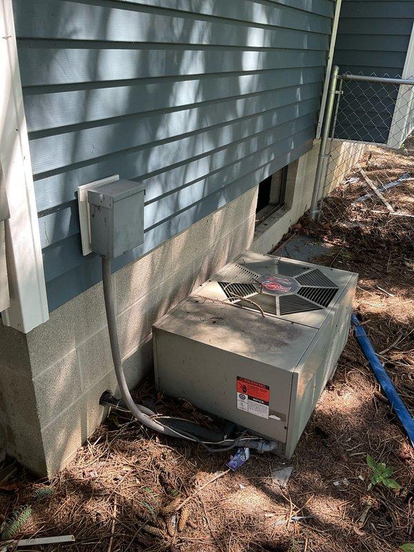 Completed comprehensive site evaluation for complete HVAC system replacement. Documented existing Goodman furnace installation in basement mechanical room along with current ductwork configuration, and assessed outdoor condensing unit positioned against building exterior with electrical disconnect and conduit routing. Provided detailed replacement quote covering both indoor and outdoor equipment components.