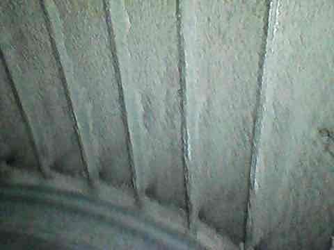 Completed preventive maintenance tune-up on HVAC system per PTU BOGO8-1279 protocol. Inspected evaporator coil assembly showing normal condensation accumulation on refrigerant lines, indicating proper system operation. All components functioning within manufacturer specifications at time of inspection.