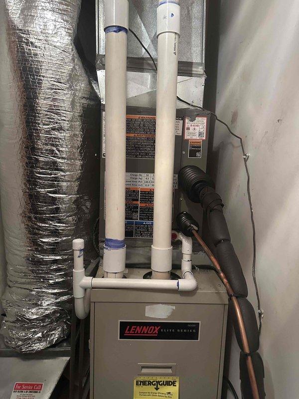 Completed full air conditioning system installation including outdoor condensing unit and indoor air handler components. Installed Lennox Elite Series equipment with proper refrigerant line connections, PVC intake and exhaust venting, and flexible ductwork integration. Performed electrical connections, mechanical hookup, and system startup with pressure testing showing proper refrigerant charge at 164.5 psig on high side. Verified all components operational and system reconnected to power supply.