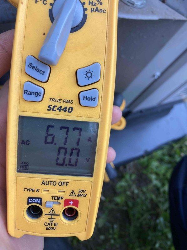 Completed preventive maintenance agreement visit for residential air conditioning and heating system. Performed electrical diagnostics on outdoor condensing unit, measuring 6.77 amps current draw which indicates normal compressor operation. Inspected indoor air handler unit and verified air filtration system is installed and functional with blue media filter in place.