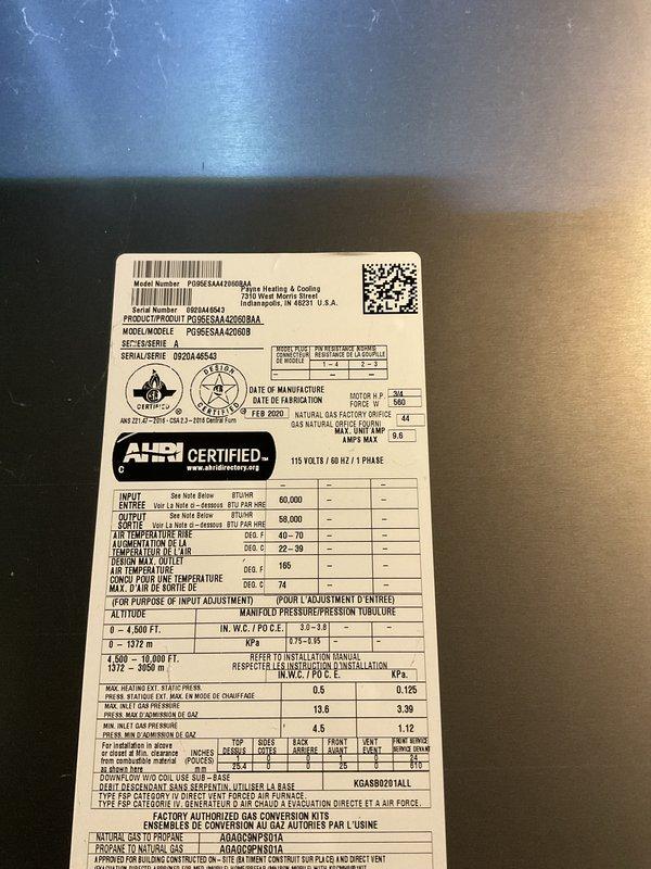 Completed preventive maintenance tune-up on Goodman gas furnace model PDBF4EAF090BA5A. Inspected heat exchanger coils and found moderate dust accumulation between fins; documented equipment specifications and current operating condition with photos for service records.