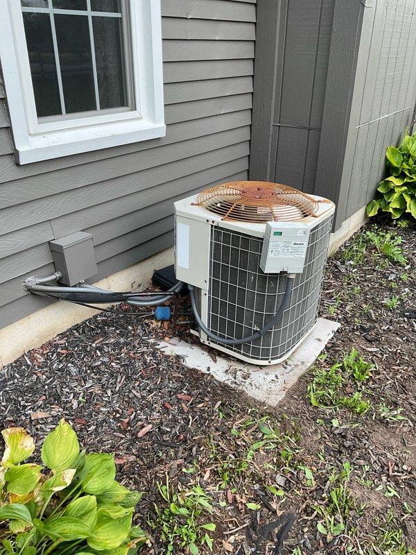 Provided estimate for complete HVAC system replacement including 16-year-old Payne furnace and outdoor AC condenser unit. Current air conditioning system is operational but experiencing refrigerant leak causing water damage and basement flooding. Equipment located in basement mechanical room with outdoor condenser positioned on concrete pad adjacent to home exterior.