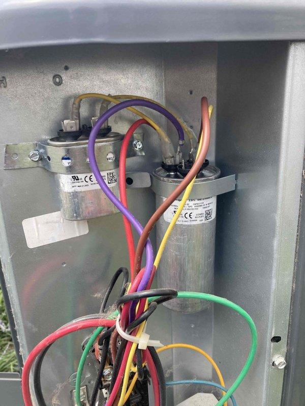 # AC No Cool - Capacitor Failure

Responded to service call for air conditioning system not cooling. Upon inspection, diagnosed failed dual run capacitor in condensing unit. Tested capacitor with multimeter showing 0.81 microfarads, significantly below rated specification. Replaced defective capacitor with properly rated component, verified all electrical connections secure, and confirmed system returned to normal cooling operation.