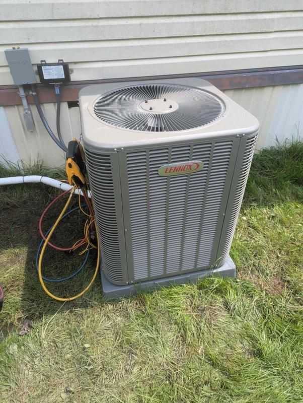 Completed full HVAC system installation including a 60,000 BTU gas furnace and 3-ton Lennox air conditioning condenser unit positioned in the rear yard. The outdoor condenser was mounted on a composite pad with proper electrical disconnect and refrigerant line connections established. Interior mechanical closet installation included furnace placement with associated PVC venting system, copper refrigerant lines, flexible ductwork connections, and humidifier integration. All components were properly secured, sealed, and connected per manufacturer specifications. System was charged with refrigerant, electrical connections verified, and all equipment tested for proper operation and airflow.