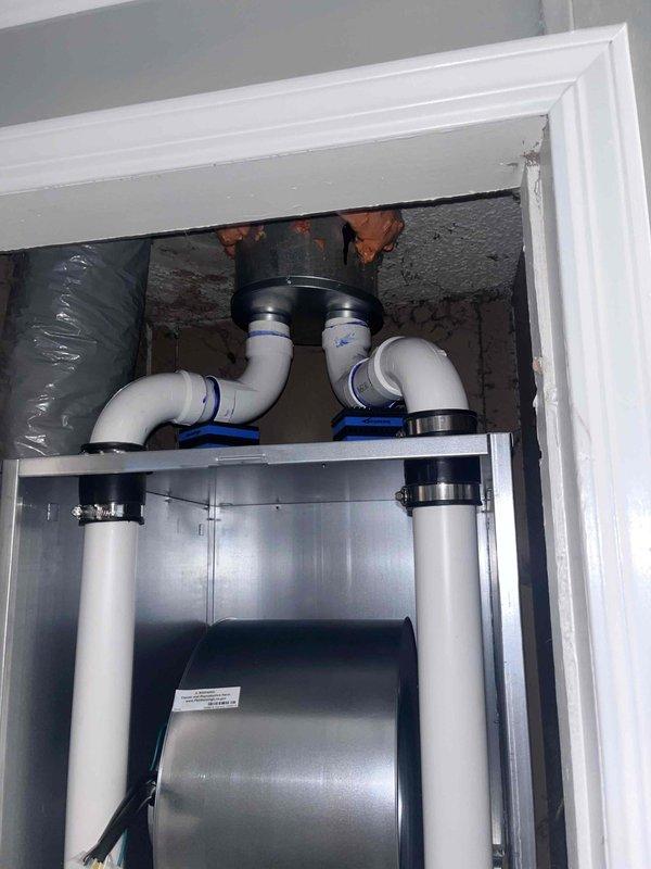 Completed full HVAC system installation including a 60,000 BTU gas furnace and 3-ton Lennox air conditioning condenser unit positioned in the rear yard. The outdoor condenser was mounted on a composite pad with proper electrical disconnect and refrigerant line connections established. Interior mechanical closet installation included furnace placement with associated PVC venting system, copper refrigerant lines, flexible ductwork connections, and humidifier integration. All components were properly secured, sealed, and connected per manufacturer specifications. System was charged with refrigerant, electrical connections verified, and all equipment tested for proper operation and airflow.