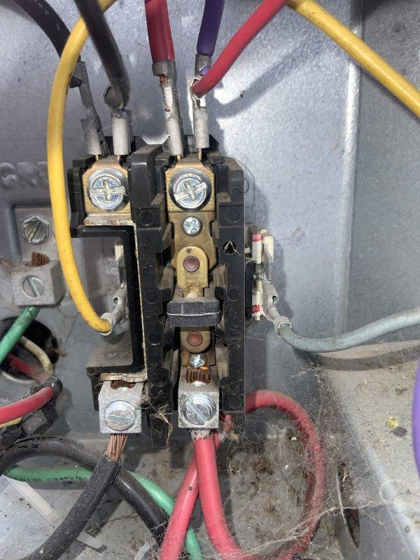 # HVAC Service Completed

Responded to no cooling complaint on residential central air conditioning system. Upon arrival, performed visual inspection of outdoor condensing unit and accessed electrical compartment. Utilized Fieldpiece clamp meter to diagnose electrical issues and measure amperage draw on compressor circuit.

Inspection revealed failed contactor with severely oxidized and corroded brass terminal connections. Contactor showed visible signs of wear, pitting on contact surfaces, and electrical arcing damage. Oxidation on terminal screws indicated prolonged exposure to moisture and environmental elements, causing poor electrical connectivity and preventing compressor from engaging properly.

Replaced defective contactor with new unit rated to manufacturer specifications. Cleaned all electrical terminal connections, removed oxidation buildup, and ensured proper wire seating at all connection points. Verified all wire insulation integrity and secured connections with appropria
