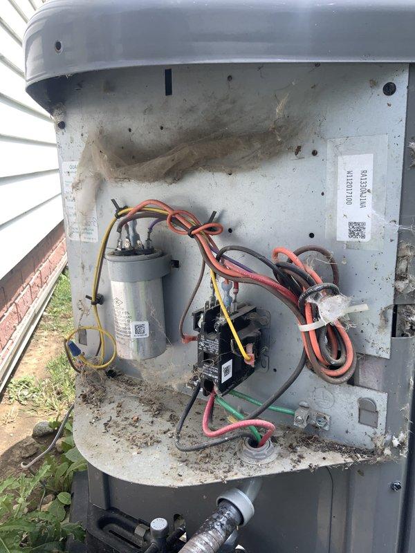 Responded to no cooling complaint on 9-year-old air conditioning system blowing warm air. Upon arrival, removed access panel from outdoor condensing unit and performed diagnostic inspection of electrical and mechanical components. Identified failed dual run capacitor as primary cause of system failure, preventing both compressor and condenser fan motor from operating. Inspected contactor, wiring connections, and relay components for additional issues. Replaced defective capacitor with manufacturer-specified replacement, verified proper microfarad ratings for compressor and fan motor circuits. Cleaned accumulated debris, dirt, and cobwebs from interior compartment to ensure proper airflow and prevent future electrical issues. Tested all electrical connections, confirmed proper voltage supply, and verified secure mounting of all components. Cycled system through complete startup sequence, confirmed compressor engagement and condenser fan motor operation. Monitored system performance to e
