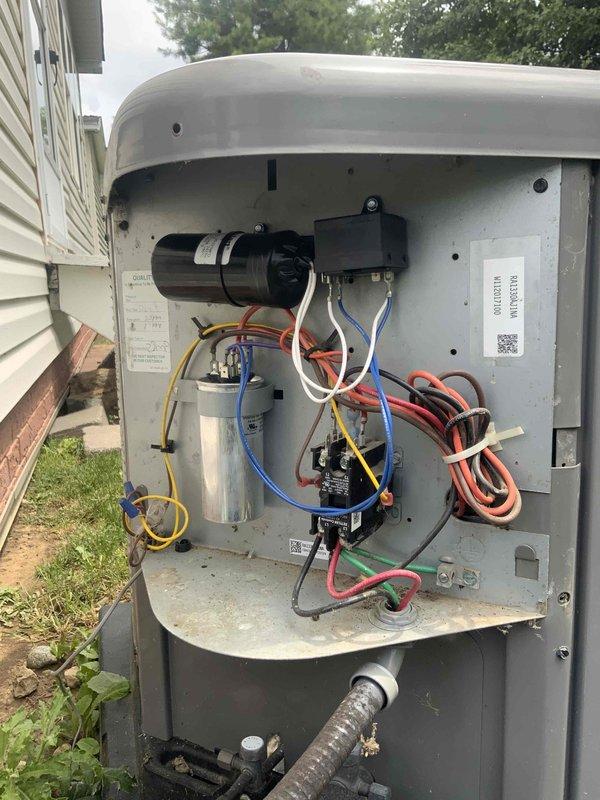 Responded to no cooling complaint on 9-year-old air conditioning system blowing warm air. Upon arrival, removed access panel from outdoor condensing unit and performed diagnostic inspection of electrical and mechanical components. Identified failed dual run capacitor as primary cause of system failure, preventing both compressor and condenser fan motor from operating. Inspected contactor, wiring connections, and relay components for additional issues. Replaced defective capacitor with manufacturer-specified replacement, verified proper microfarad ratings for compressor and fan motor circuits. Cleaned accumulated debris, dirt, and cobwebs from interior compartment to ensure proper airflow and prevent future electrical issues. Tested all electrical connections, confirmed proper voltage supply, and verified secure mounting of all components. Cycled system through complete startup sequence, confirmed compressor engagement and condenser fan motor operation. Monitored system performance to e